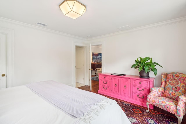 bedroom featuring dark hardwood / wood-style floors and crown molding