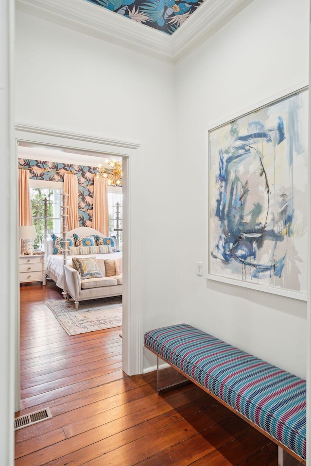 interior space featuring wood-type flooring and ornamental molding