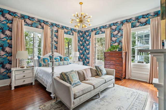 bedroom with a notable chandelier, wood-type flooring, and ornamental molding