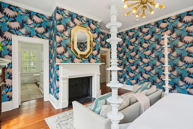 living room featuring hardwood / wood-style floors, a chandelier, and ornamental molding