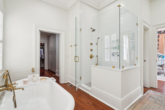 bathroom featuring hardwood / wood-style floors, separate shower and tub, and crown molding