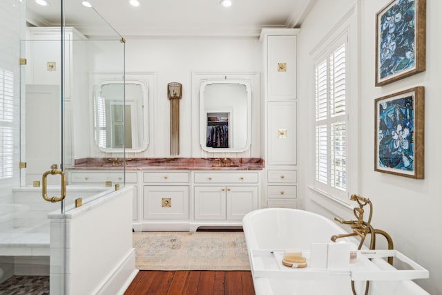 bathroom featuring hardwood / wood-style floors, vanity, crown molding, and independent shower and bath