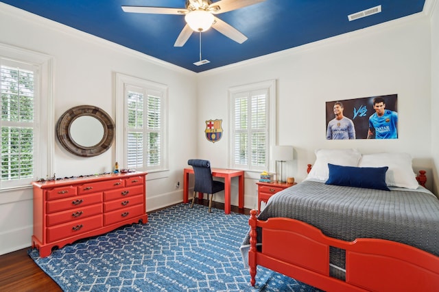 bedroom with multiple windows, ceiling fan, dark hardwood / wood-style flooring, and ornamental molding