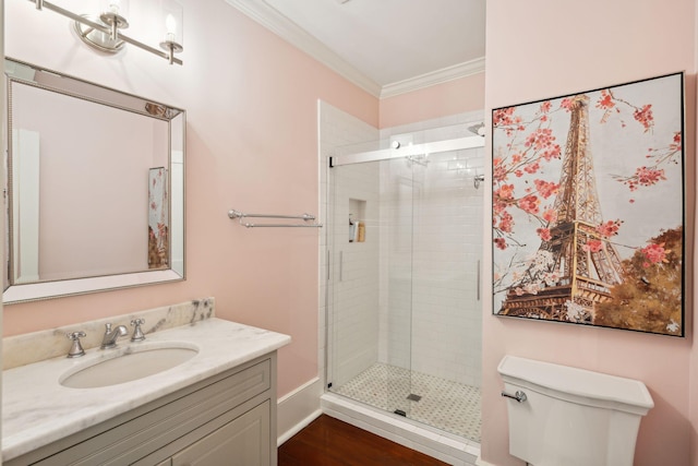 bathroom with vanity, crown molding, toilet, walk in shower, and wood-type flooring