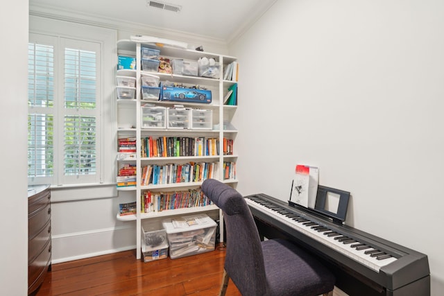 home office with dark hardwood / wood-style floors and ornamental molding