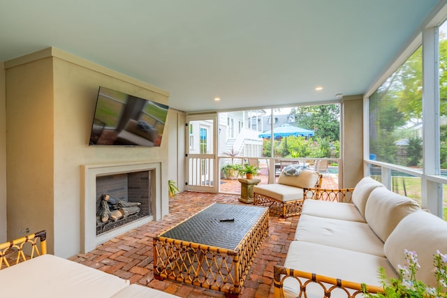 living room with a fireplace and expansive windows