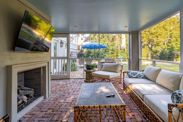 sunroom / solarium featuring a fireplace