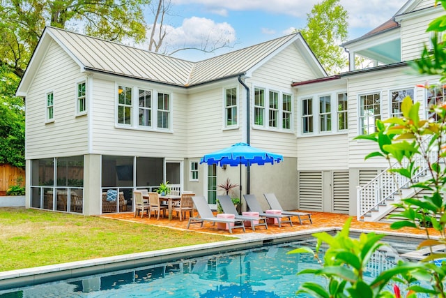 rear view of house featuring a lawn and a patio area