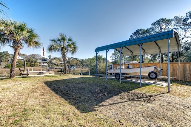 view of yard featuring a carport and fence