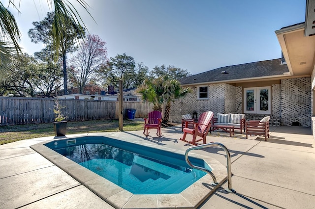 view of pool with french doors, a patio, a fenced in pool, and a fenced backyard