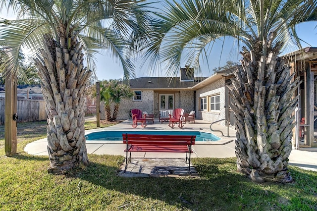 view of pool featuring a fenced in pool, fence, french doors, a yard, and a patio