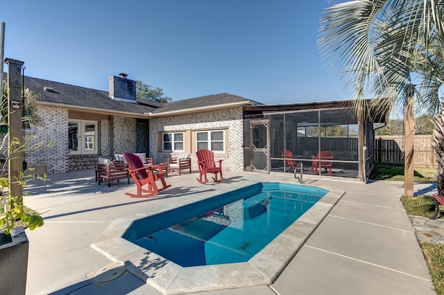 view of swimming pool featuring a fenced in pool, a sunroom, a patio, and fence