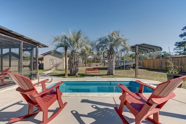 view of pool with an outbuilding, a storage shed, a fenced in pool, fence private yard, and a patio area