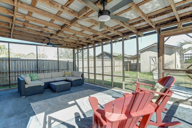 sunroom / solarium featuring a ceiling fan