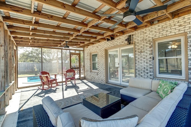 sunroom / solarium featuring ceiling fan