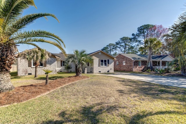 single story home featuring crawl space, driveway, and a front yard