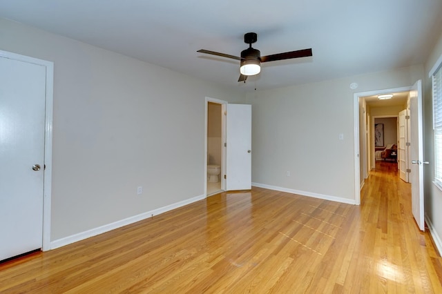 unfurnished bedroom featuring baseboards, a ceiling fan, light wood-style flooring, and ensuite bathroom