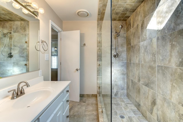 full bathroom with vanity and a tile shower