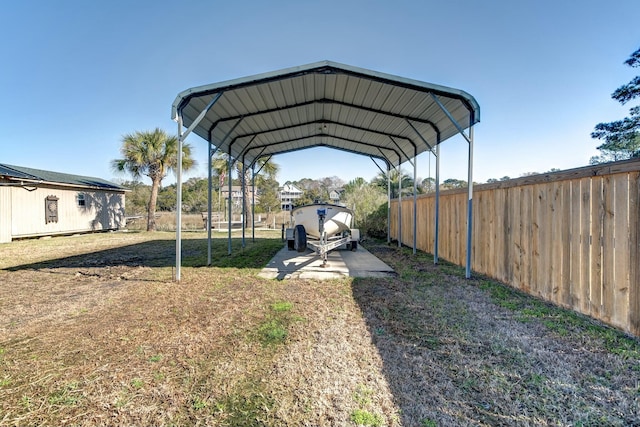 view of parking featuring a detached carport and fence