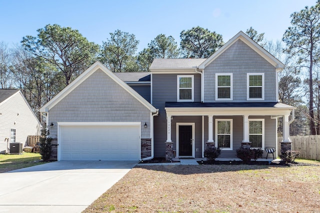 craftsman inspired home featuring a porch, central AC, fence, a garage, and driveway