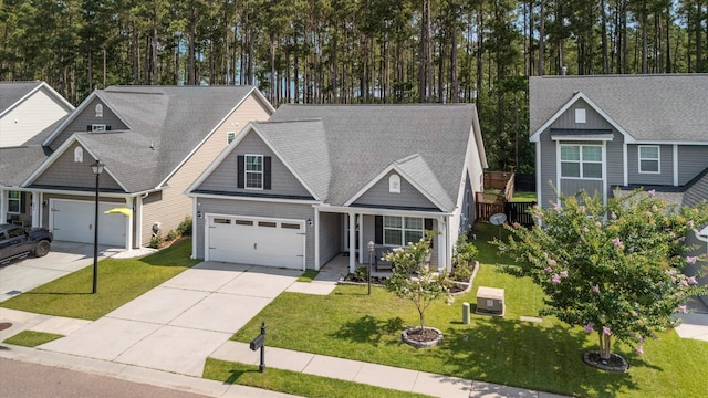491 Foxbank Plantation Blvd, Moncks Corner, SC 29461 - craftsman inspired home featuring covered porch, driveway, a front yard, roof with shingles, and view of wooded area
