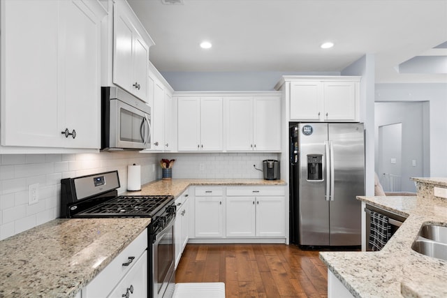 491 Foxbank Plantation Blvd, Moncks Corner, SC 29461 - kitchen with stainless steel appliances, white cabinets, dark wood finished floors, backsplash, and recessed lighting