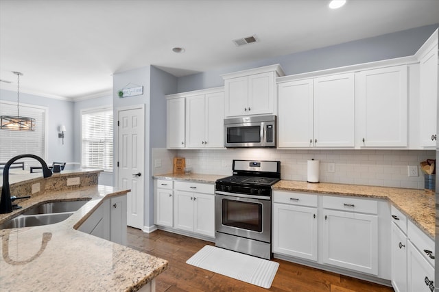 491 Foxbank Plantation Blvd, Moncks Corner, SC 29461 - kitchen with appliances with stainless steel finishes, white cabinetry, tasteful backsplash, ornamental molding, and recessed lighting