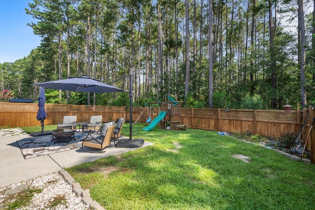 491 Foxbank Plantation Blvd, Moncks Corner, SC 29461 - fenced backyard with an outdoor fire pit, a playground, and a patio area