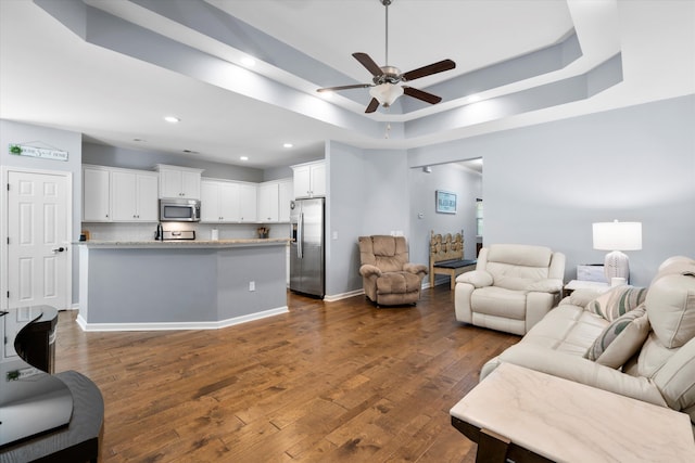 491 Foxbank Plantation Blvd, Moncks Corner, SC 29461 - living room featuring a raised ceiling, ceiling fan, recessed lighting, and dark wood-type flooring