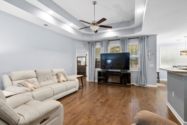 491 Foxbank Plantation Blvd, Moncks Corner, SC 29461 - living area featuring a tray ceiling, dark wood-type flooring, and a ceiling fan