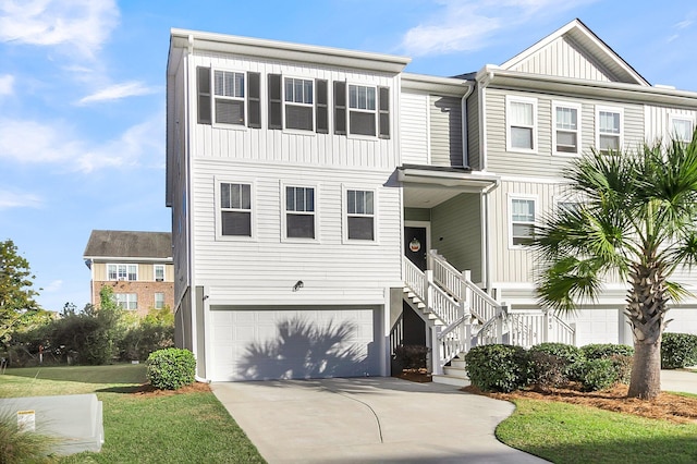 681 Mclernon Trce, Johns Island, SC 29455 - view of property with an attached garage, driveway, board and batten siding, and stairway