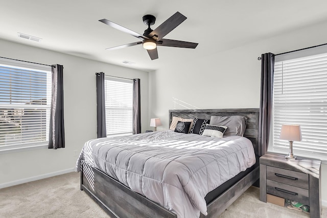 bedroom featuring light colored carpet and ceiling fan