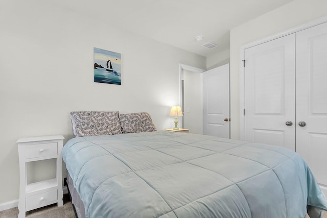 bedroom featuring a closet and light colored carpet