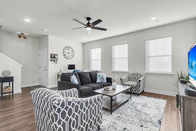 living room featuring wood-type flooring and ceiling fan