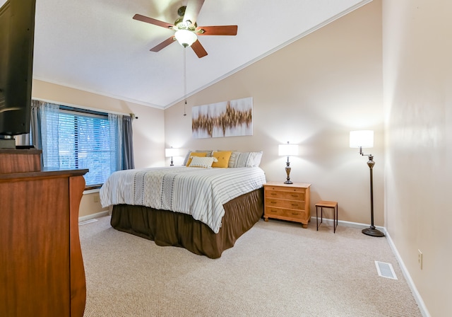 carpeted bedroom featuring ceiling fan, crown molding, and vaulted ceiling