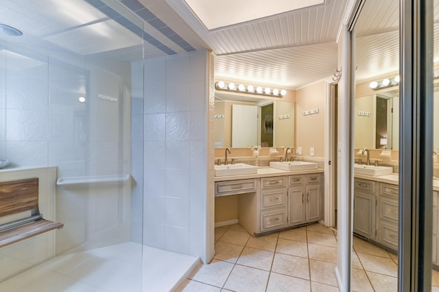 bathroom featuring vanity, a shower, and tile patterned flooring