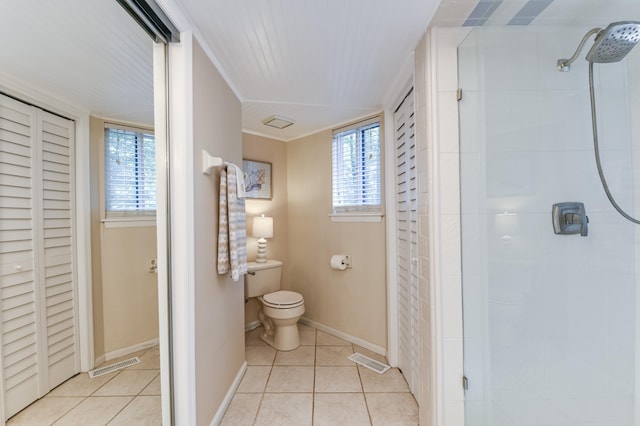 bathroom featuring walk in shower, toilet, and tile patterned flooring