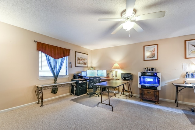 office area with a textured ceiling, ceiling fan, and carpet