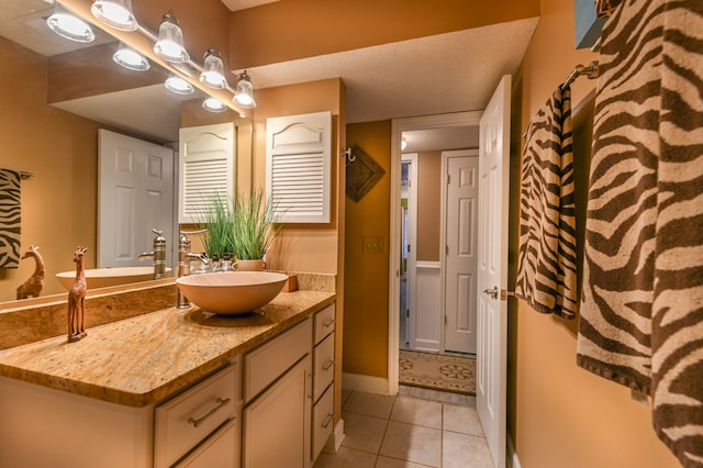 bathroom featuring tile patterned flooring and vanity