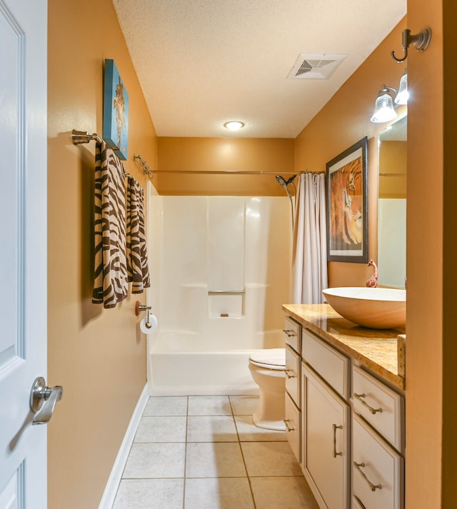 full bathroom featuring tile patterned flooring, shower / bath combo, toilet, vanity, and a textured ceiling