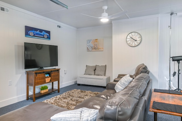 living room featuring wood walls and ceiling fan