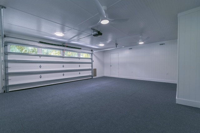 garage with ceiling fan and a garage door opener