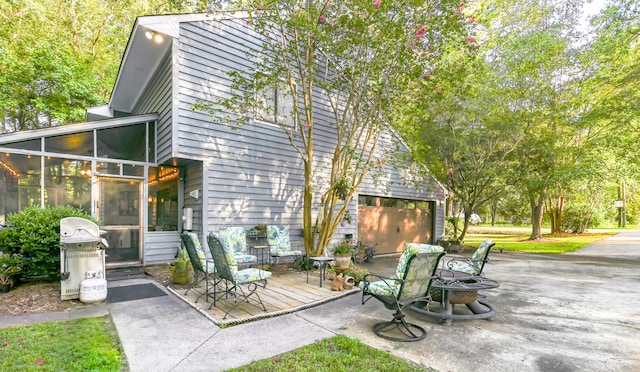 view of patio with grilling area and a sunroom