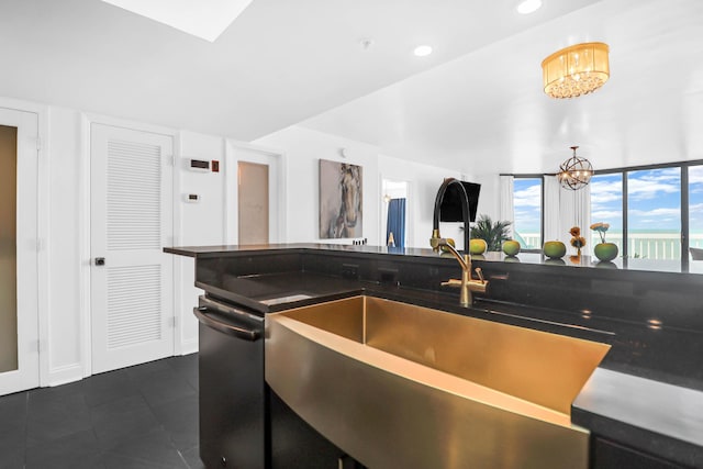 kitchen featuring an inviting chandelier, stainless steel dishwasher, and sink