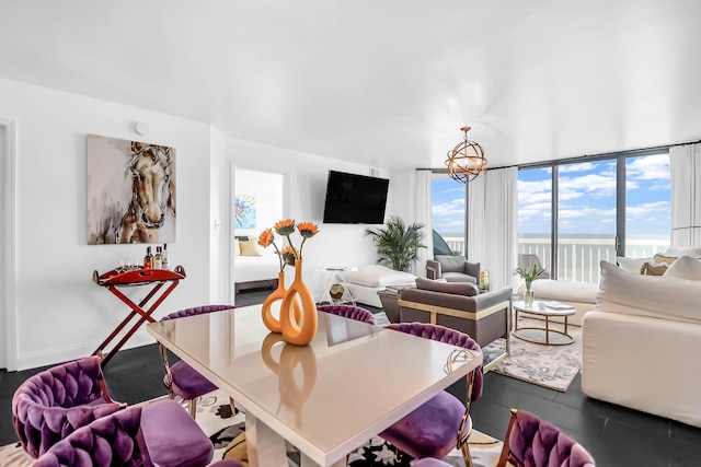 living room with a chandelier and a wall of windows