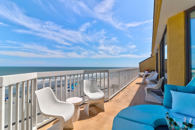 balcony with a water view and a beach view