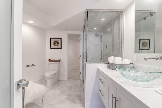 bathroom featuring vanity, toilet, and an enclosed shower