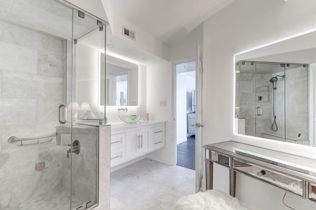 bathroom with tile patterned flooring, vanity, and a shower with door