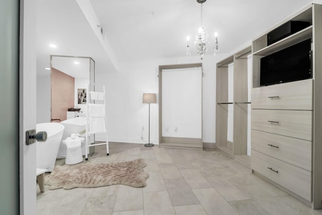 interior space with a tub to relax in and a notable chandelier