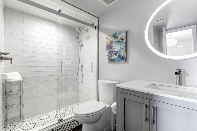 bathroom featuring vanity, toilet, and a shower with door